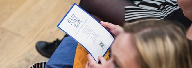 person reading a Bloomsbury pamplet